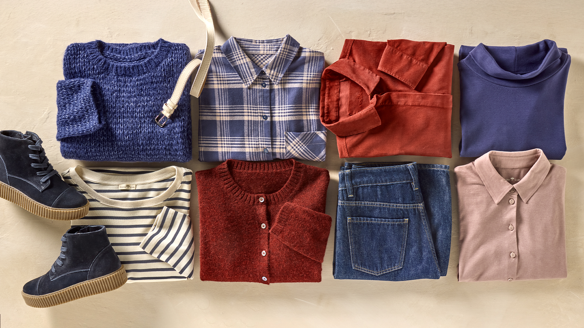 Gefaltete Kleidung und Schuhe übersichtlich auf hellem Hintergrund
