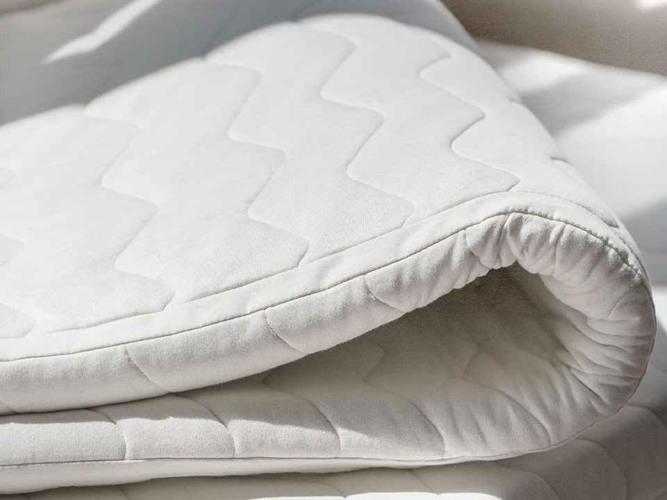 Topper liegt auf Matratze