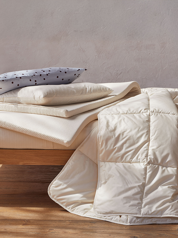 Ökologische Schlaftextilien auf einer Holzbank