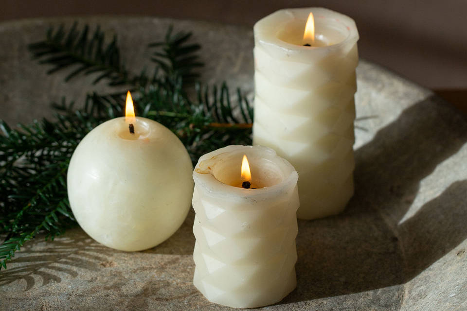 Kerzen mit Tannenzweigen warmes Licht ruhige winterliche Atmosphäre