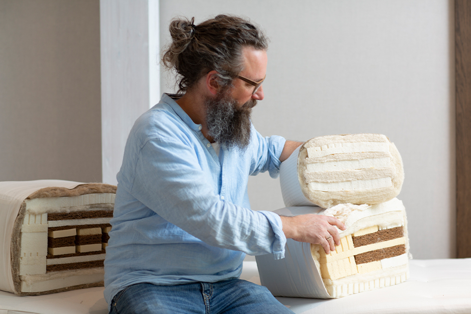 Mann zeigt den Kern einer Matratze