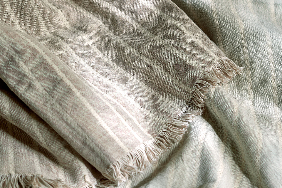 Graue Kuscheldecke mit weißen Streifen