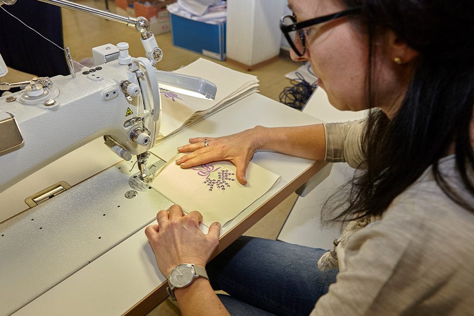 Mitarbeiterin näht die Lavendelkissen für Grüne Erde