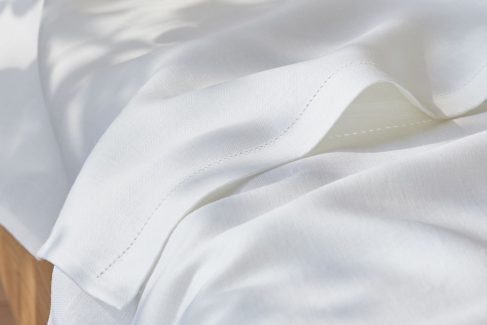 Betttuch Edna auf einem Massivholzbett