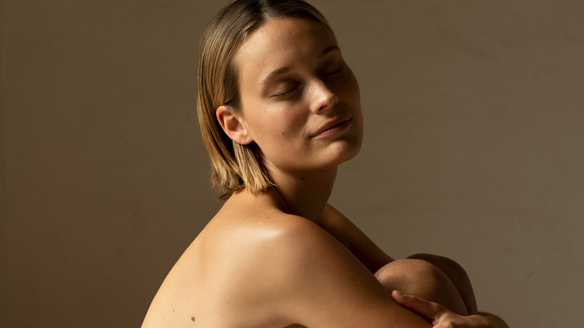 Frau sitzt mit den Knien vor der Brust