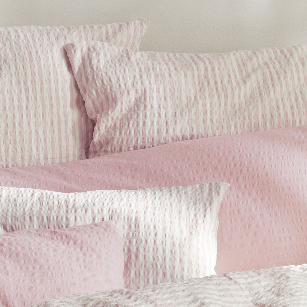 Pinke Bettwäsche auf Bett drapiert