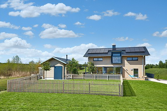 Ansicht: Musterhaus „Heimat 4.0" von vorne mit Garten