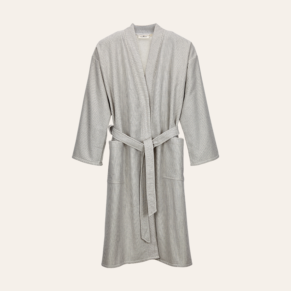 Beiger Bademantel auf weißem Hintergrund