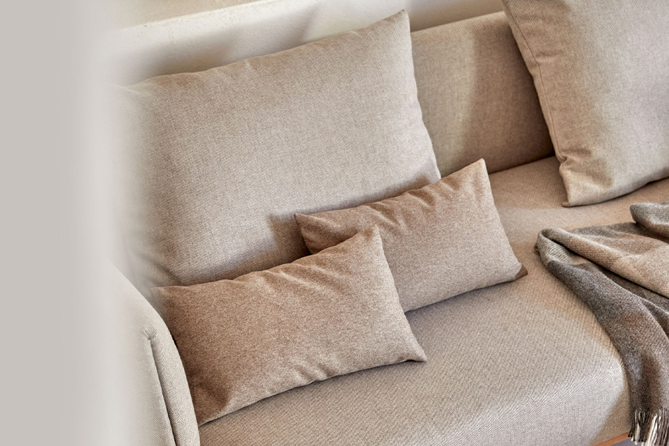 Detailaufnahme von beigem Sofa mit weichen Kissen