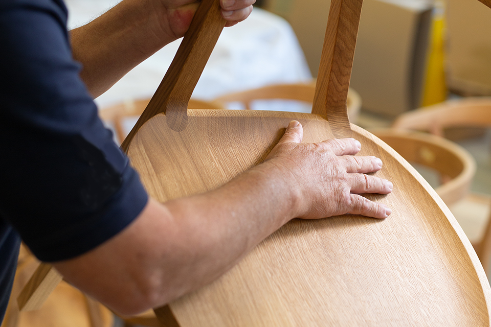 Hand streift über Holzfläche aus Buche
